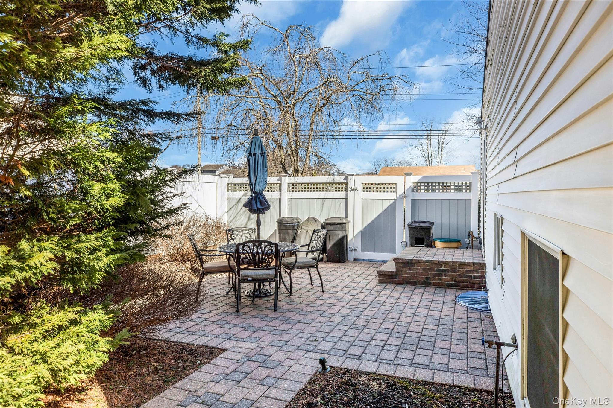114 Lowell Road Sayville, NY 11782 - Photo 19 of 20 a backyard of a house with outdoor seating