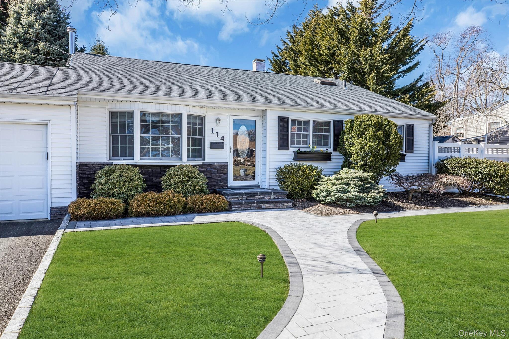 114 Lowell Road Sayville, NY 11782 - Photo 3 of 20 a front view of a house with a yard