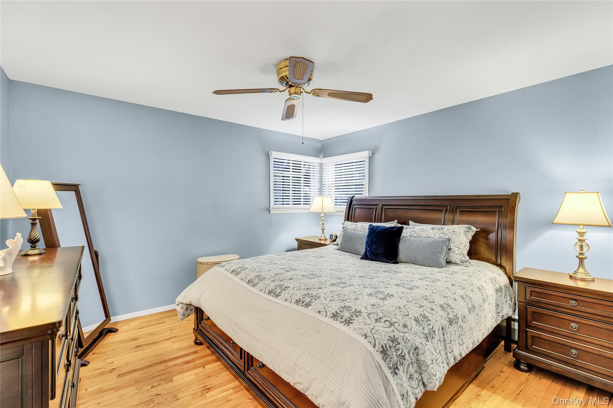 114 Lowell Road Sayville, NY 11782 - Photo 10 of 20 a bedroom with a large bed and a chandelier
