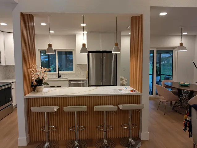 a large kitchen with a table and chairs