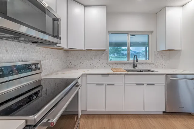 a view of a dining room with furniture large windows and garden view