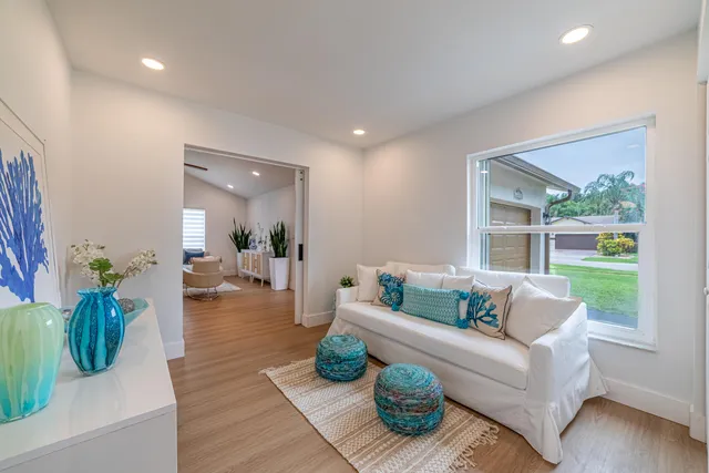 a view of a house with a yard and sitting area