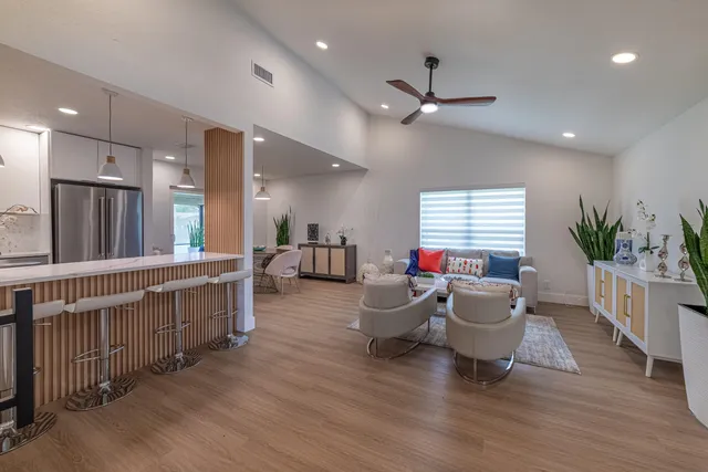 a living room with furniture window and wooden floor
