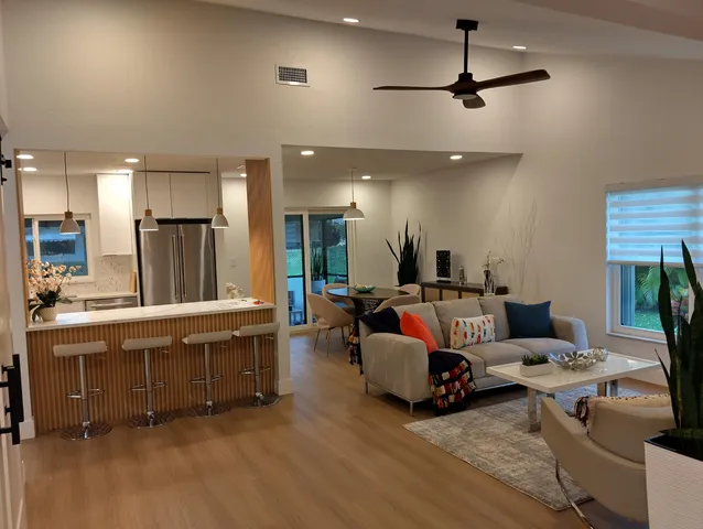a view of an empty room with potted plant and wooden floor