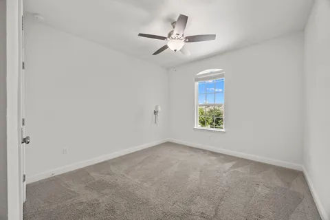a room with furniture projector and screen
