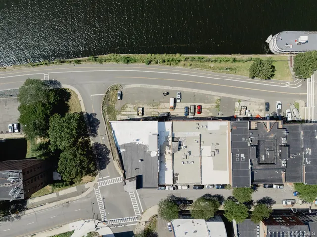 a view of a hallway with entryway mirror and window