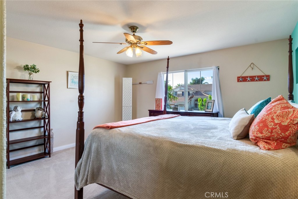 20885 Bakal Drive Riverside, CA 92508 - Photo 25 of 47 a bedroom with a bed and a chandelier