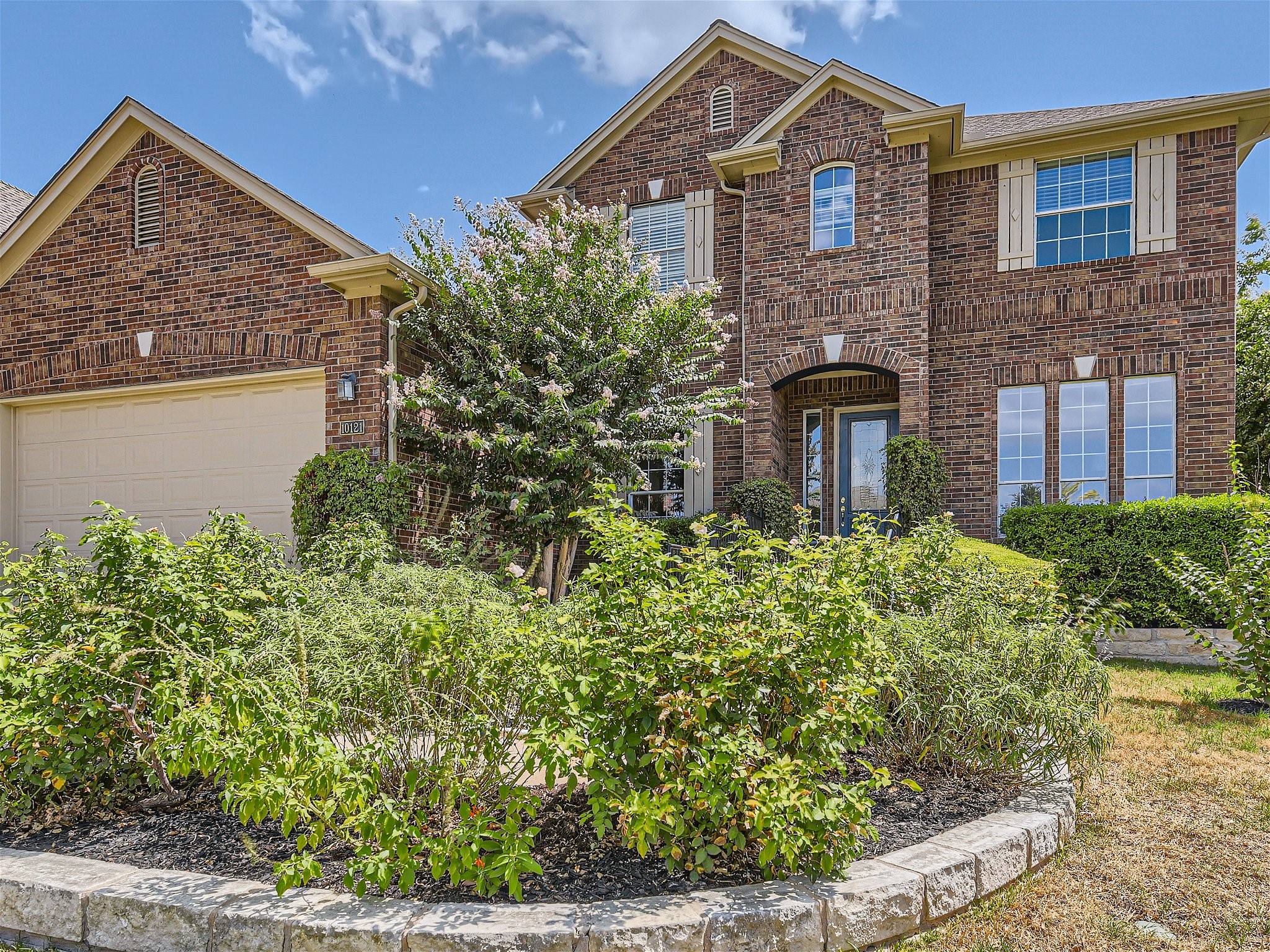 Lovely 2 story executive brick home with accent exterior shutters