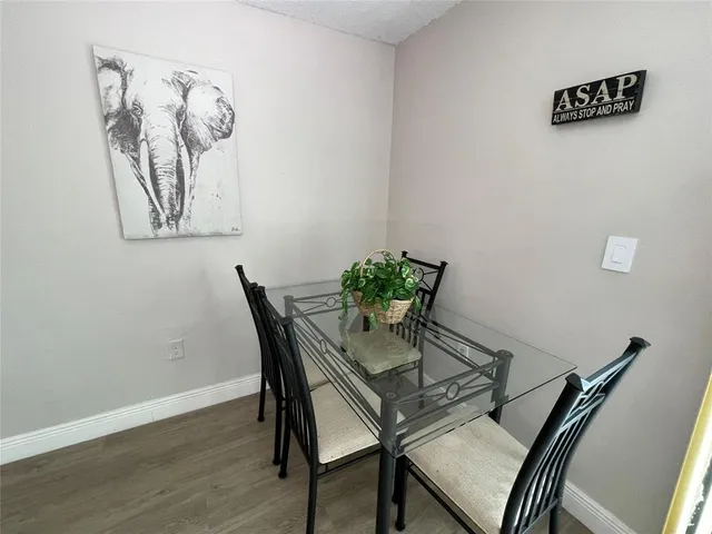 a view of a room with furniture and wooden floor