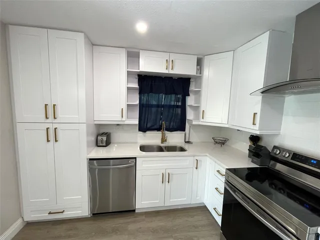 a kitchen with a sink stove and cabinets