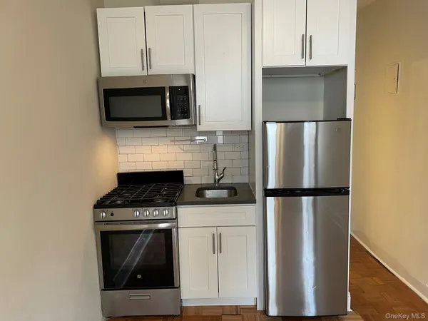 a kitchen with a stove microwave and refrigerator