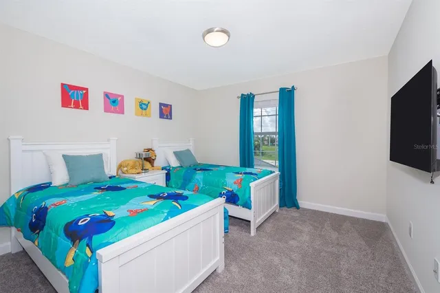 a bedroom with a bed and a television