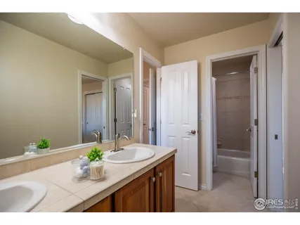 a bathroom with a granite countertop sink a mirror and a