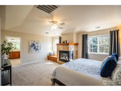 a spacious bedroom with a bed and a fireplace