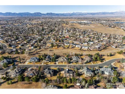 an aerial view of residential houses with outdoor space and mountain view