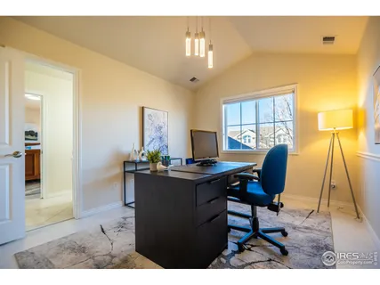 a view of a dining room with furniture and a chandelier