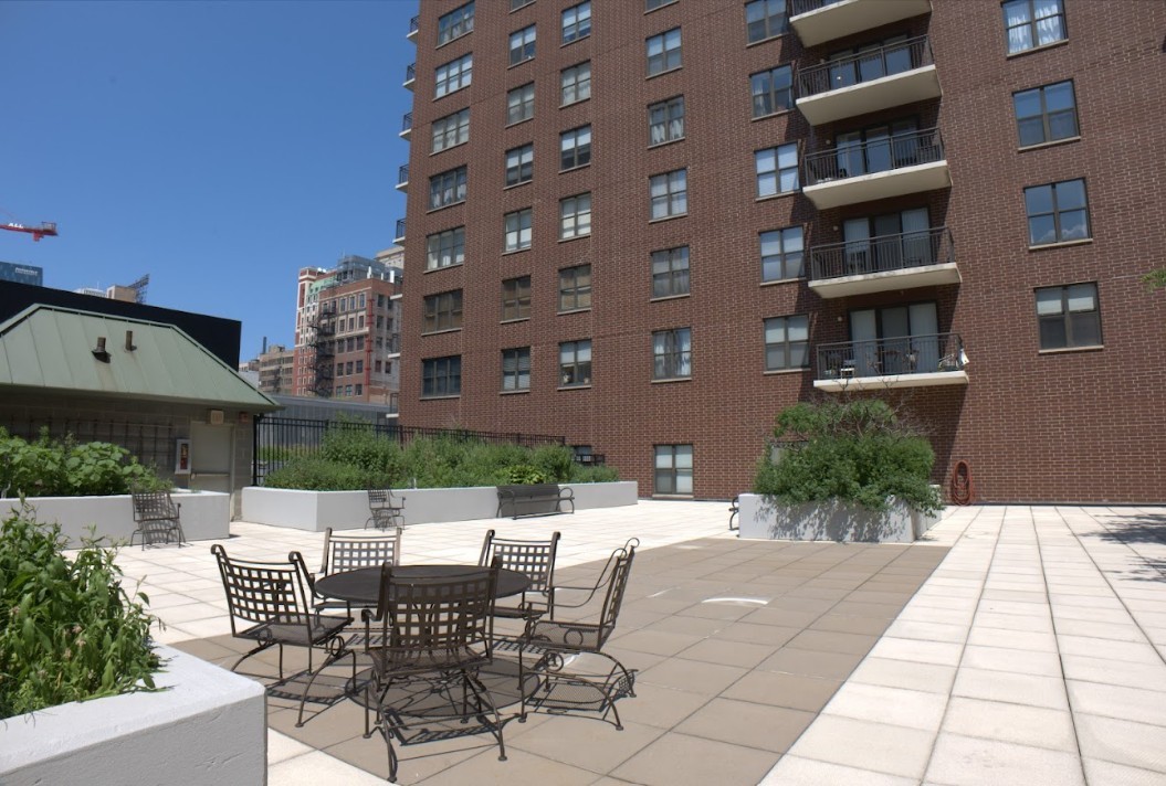 41 East 8th Street, Unit 1702 Chicago, IL 60605 - Photo 18 of 20 a view of a patio with table and chairs and potted plants