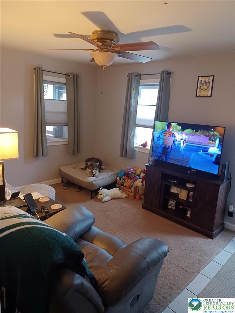2543 South Law Street Allentown, PA 18103 - Photo 16 of 17 a living room with furniture a fireplace and a flat screen tv