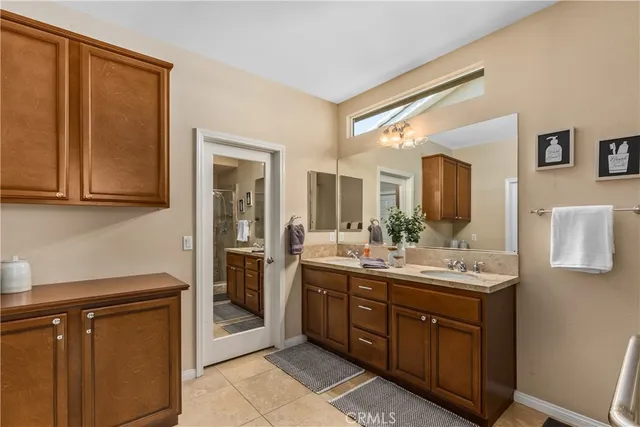 a spacious bathroom with a granite countertop sink a mirror and a