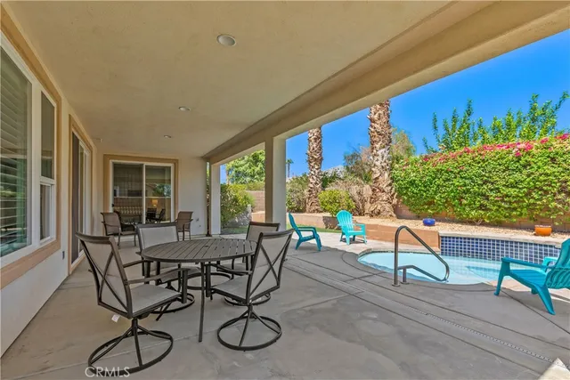 a view of a patio with table and chairs and potted plants