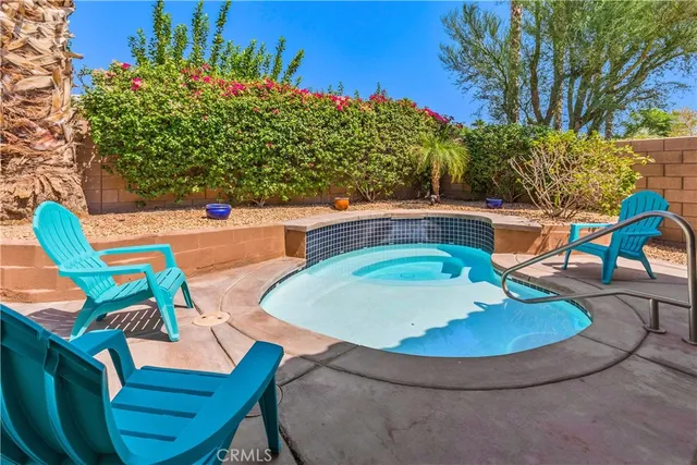 a view of a swimming pool with a lounge chairs in patio