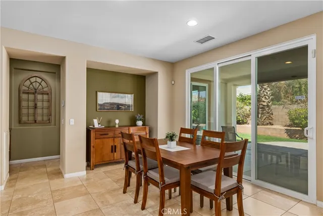 a dining room with furniture and window