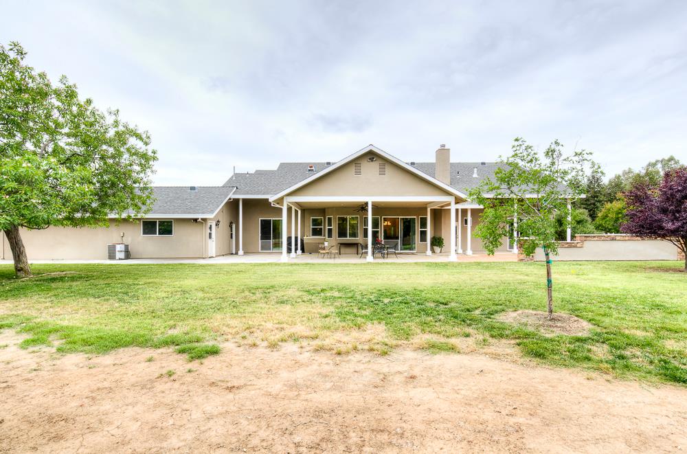 17465 Monreal Road Madera, CA 93636 - Photo 9 of 59 a front view of a house with a yard