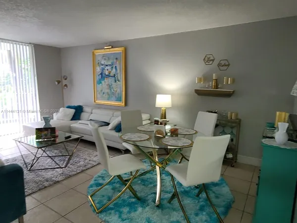 a living room with furniture a rug and a window