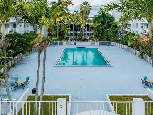 a view of backyard of house with outdoor seating and green space