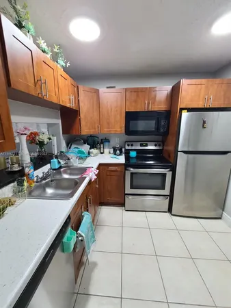 a kitchen with stainless steel appliances a stove a sink and a microwave