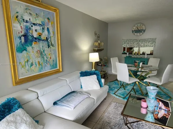 a living room with furniture and painting on the wall