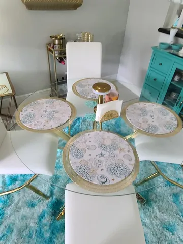 a living room with stainless steel appliances furniture and a fireplace