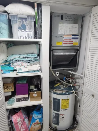 a bed room with a bed a couch and a television