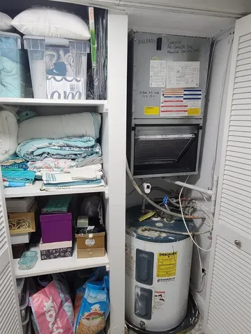 a bed room with a bed a couch and a television