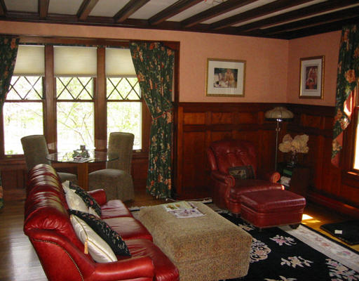 73 Dean Road Brookline, MA 02445 - Photo 2 of 7 a living room with furniture a lamp and a fireplace