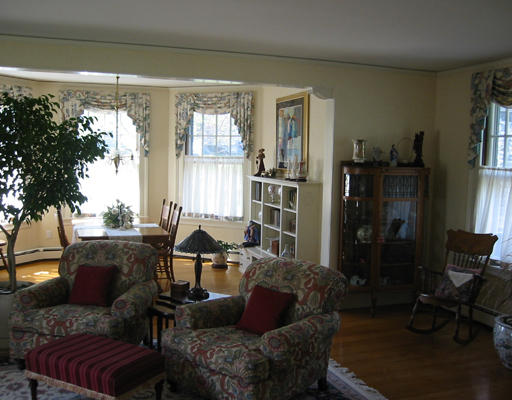 73 Dean Road Brookline, MA 02445 - Photo 3 of 7 a living room with furniture and a large window