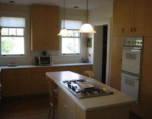 73 Dean Road Brookline, MA 02445 - Photo 7 of 7 a kitchen with kitchen island a stove and a refrigerator