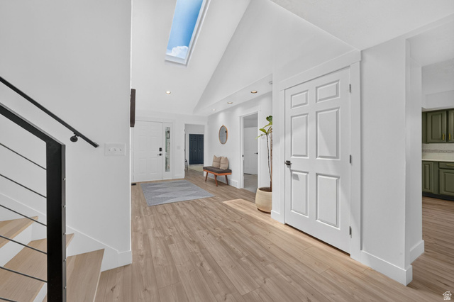 1979 Cave Hollow Way Bountiful, UT 84010 - Photo 5 of 59 Bright entryway featuring a skylight, wood-finish flooring, white paneled doors, and recessed lighting