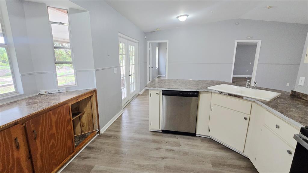 3410 15th Street Southwest Lehigh Acres, FL 33976 - Photo 11 of 31 a kitchen with granite countertop white cabinets and white appliances