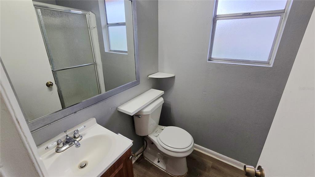 3410 15th Street Southwest Lehigh Acres, FL 33976 - Photo 14 of 31 a white toilet sitting next to a bathroom sink