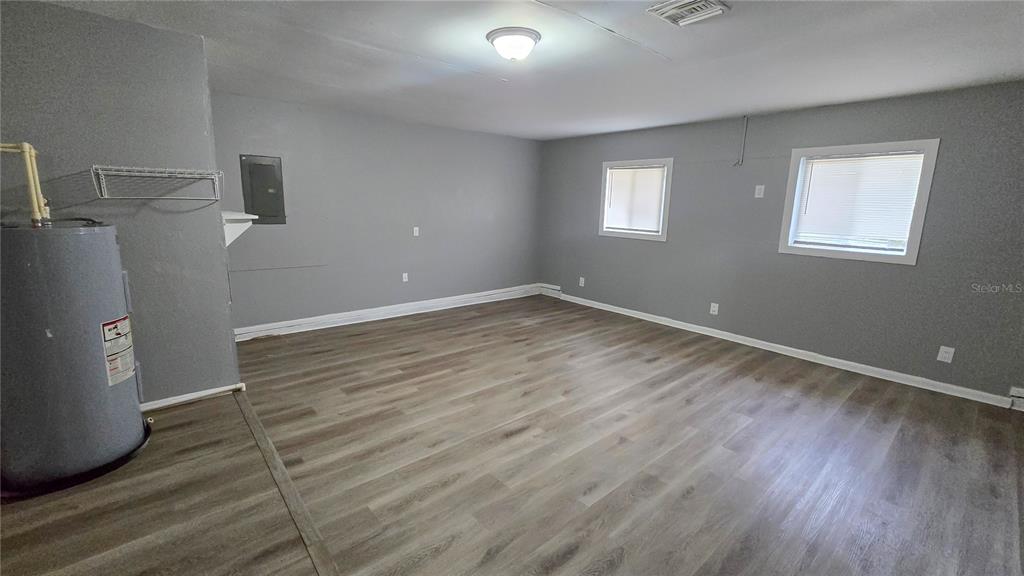 3410 15th Street Southwest Lehigh Acres, FL 33976 - Photo 16 of 31 a view of a room with wooden floor and window