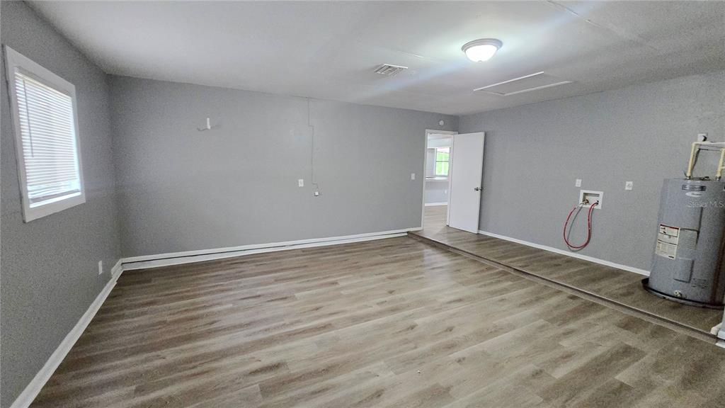 3410 15th Street Southwest Lehigh Acres, FL 33976 - Photo 17 of 31 an empty room with a empty space and windows