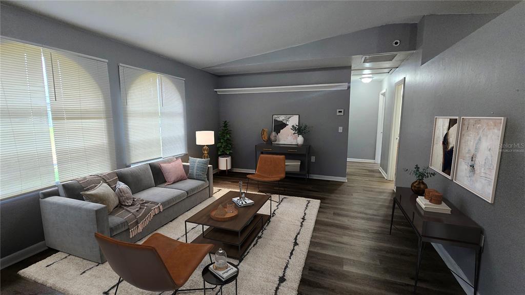 3410 15th Street Southwest Lehigh Acres, FL 33976 - Photo 2 of 31 a living room with furniture and a large mirror next to a window