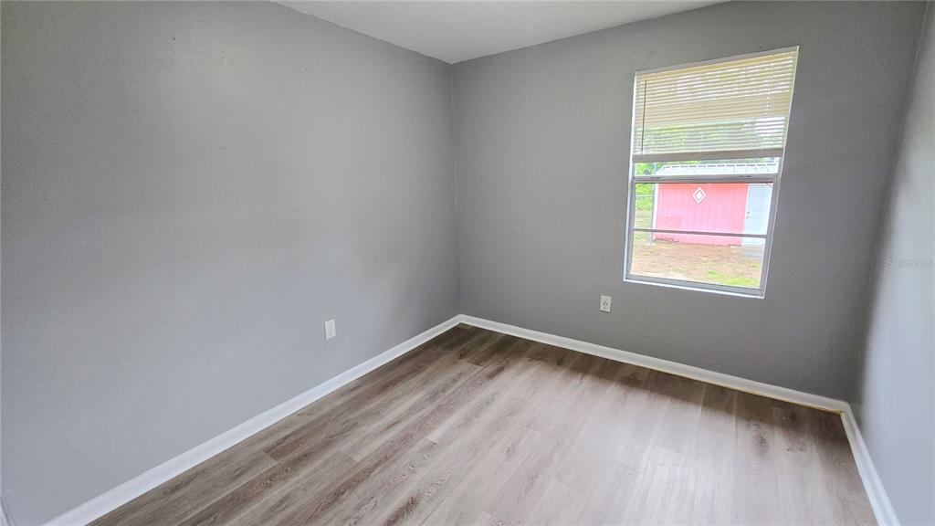 3410 15th Street Southwest Lehigh Acres, FL 33976 - Photo 22 of 31 an empty room with a window
