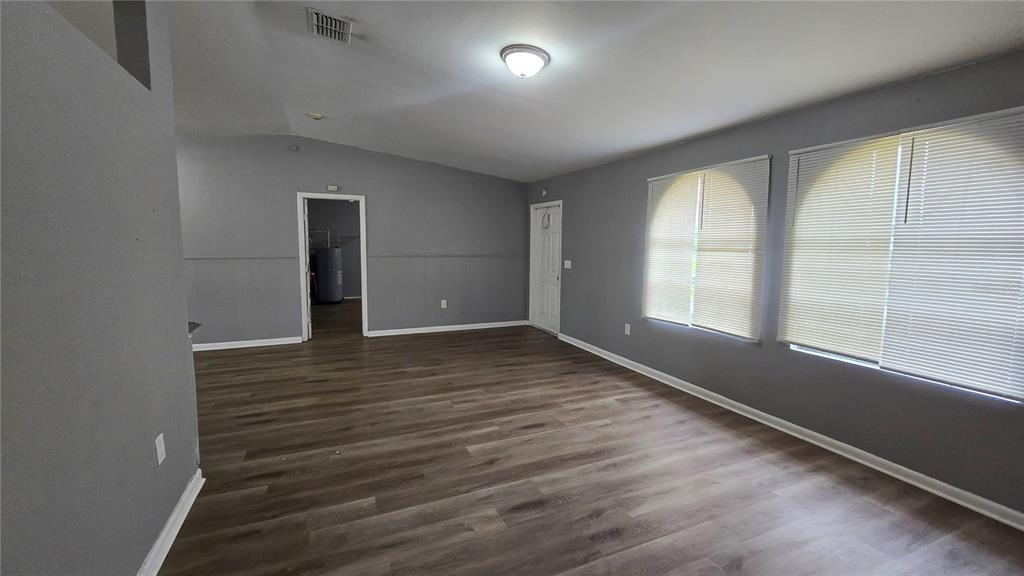 3410 15th Street Southwest Lehigh Acres, FL 33976 - Photo 23 of 31 wooden floor in an empty room with a window