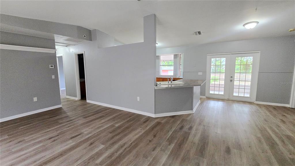 3410 15th Street Southwest Lehigh Acres, FL 33976 - Photo 25 of 31 a view of a kitchen with wooden floor and a window