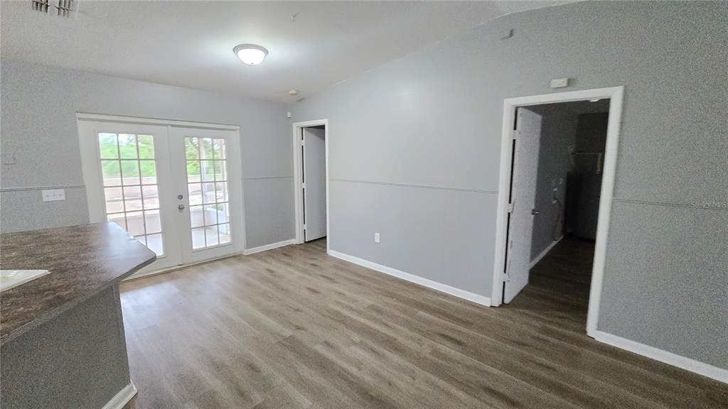 3410 15th Street Southwest Lehigh Acres, FL 33976 - Photo 26 of 31 an empty room with wooden floor and windows