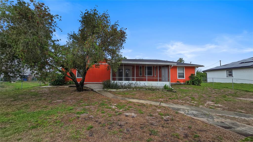 3410 15th Street Southwest Lehigh Acres, FL 33976 - Photo 30 of 31 a view of a house with a yard and tree s