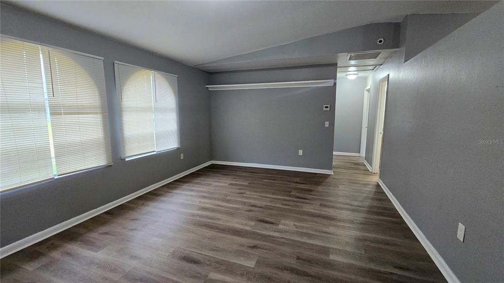 3410 15th Street Southwest Lehigh Acres, FL 33976 - Photo 3 of 31 wooden floor in an empty room with a window