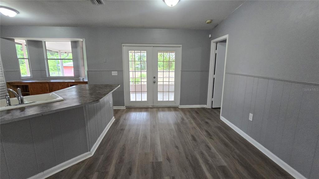 3410 15th Street Southwest Lehigh Acres, FL 33976 - Photo 7 of 31 an open kitchen with wooden floor and window